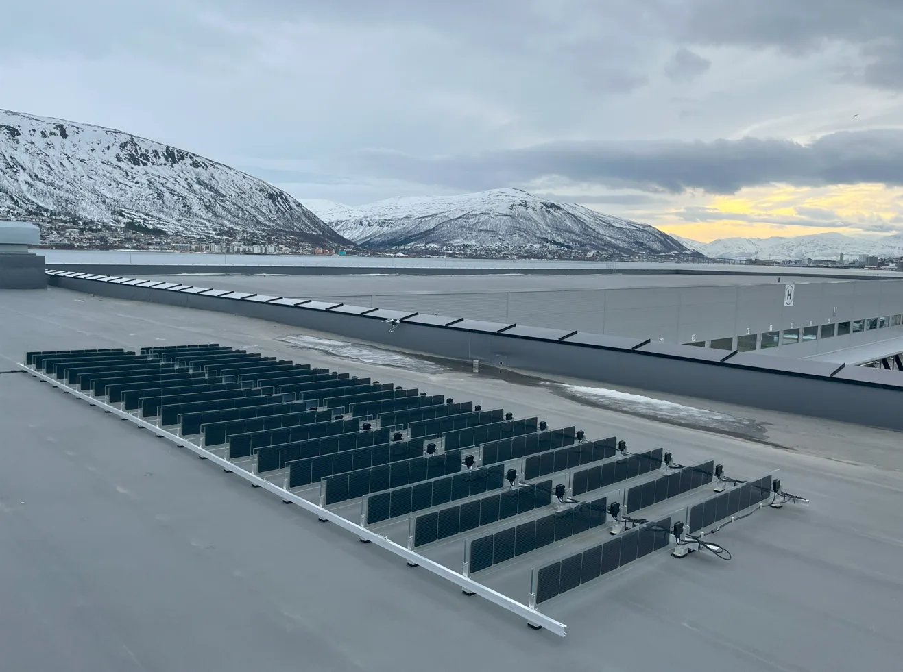 Vertical bifacial solar panels installed on a rooftop in Tromsø, Norway
